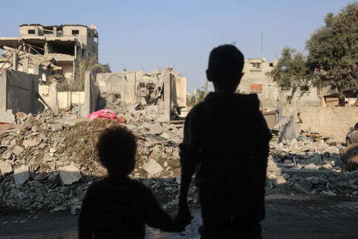 Children stare at the destruction following an Israeli strike in the Nuseirat refugee camp in the central Gaza Strip on Thursday.
