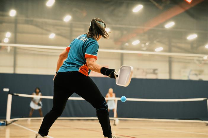 Pickleball player Alice Edington, 56, returns the ball to her opponents during a doubles match at the Florida Senior Games. Pickleball is the fastest-growing sport and it's also popular with older athletes.