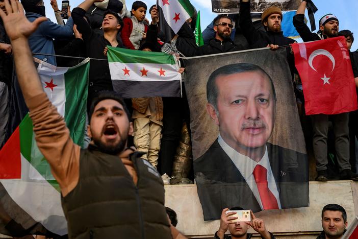 People hold a banner featuring Turkish President Recep Tayyip Erdogan as members of the Syrian community and supporters gather in Istanbul to celebrate the fall of Syrian President Bashar al-Assad in the face of an offensive by Islamist-led rebels, on Dec. 8.