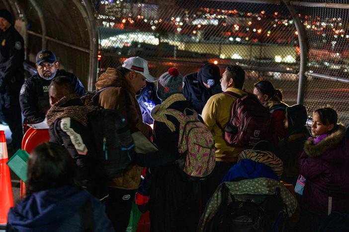 Hondurans David Melgar, 28, his wife Gabriela Maradiaga, 26, and their son Tailer Melgar, 8, have their paperwork checked by CBP agents atop the Paso del Norte Bridge to be allowed into the United States for their CBP One appointment in Ciudad Juárez, Mexico on Monday, December 9, 2024. The family waited only a few weeks to get the appointment in southern Mexico.