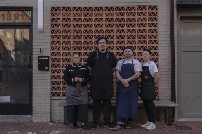 From left to right, Paola Velez, Pedro Tobar, Erik Bruner-Yang and Daniel Gonzalez pose for a photo outside the newly opened alley bar Providencia in Washington, D.C., on Dec. 12.