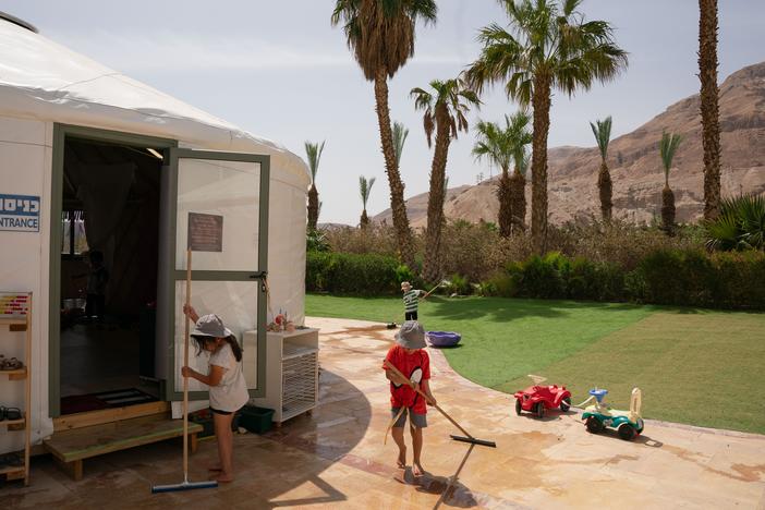 Children play with water in springtime outside a temporary classroom built for the evacuated residents of Kibbutz Be'eri. With over 90 residents killed and 30 taken hostage last Oct. 7, the kibbutz was one of the hardest hit communities that day. Nine hundred of its residents evacuated to a Dead Sea hotel and worked to maintain the unity of the community and build educational frameworks to help the children of the kibbutz recover from the trauma they went through.
