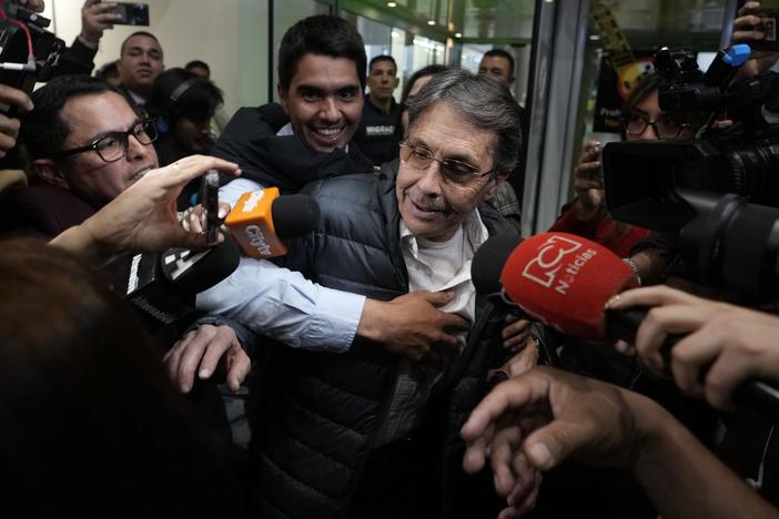 Media swarm Fabio Ochoa, center, a former member of Cartel of Medellin, upon his arrival at El Dorado airport, after being deported from the United States, in Bogota, Colombia, on Monday.