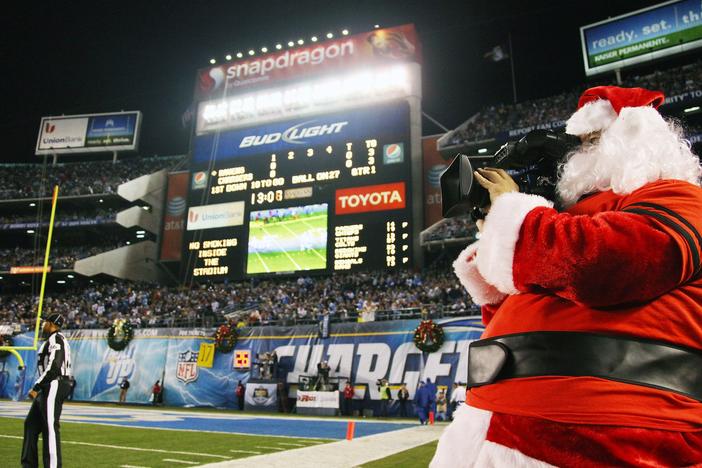 A television camera operator is dressed as Santa Claus during the Baltimore Ravens and San Diego Chargers game on Dec. 18, 2011, at Qualcomm Stadium in San Diego.