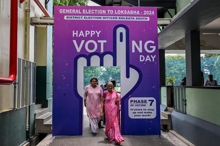 Voters leave after casting their ballot at a polling station in the final phase of voting in India's general election, in Kolkata on June 1, 2024. Artificial intelligence tools were used to create memes and images about political rivals in India and elsewhere around the world.