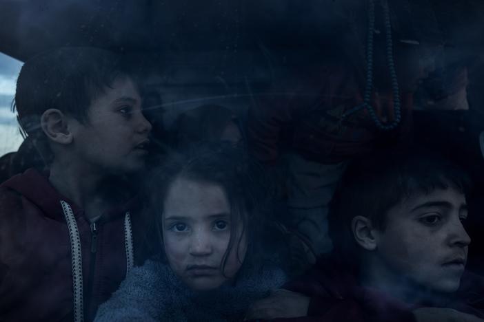 A group of Syrian children with their parents return home in the cabin of a truck, after more than eight years taking shelter in the Rukban camp for displaced people in al-Tanf, Syria, at the edge of the Jordanian border, Dec. 14.