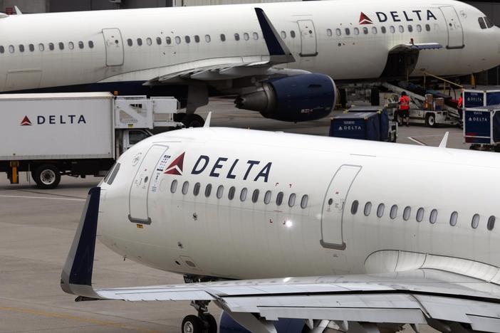FILE - A Delta Air Lines plane leaves the gate July 12, 2021, at Logan International Airport in Boston. A Delta flight from Seattle to Honolulu was delayed on Tuesday afternoon after an unticketed passenger was discovered onboard the aircraft.