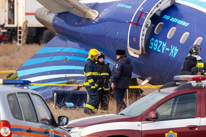 Emergency specialists work at the crash site of an Azerbaijan Airlines passenger jet near the western Kazakh city of Aktau.
