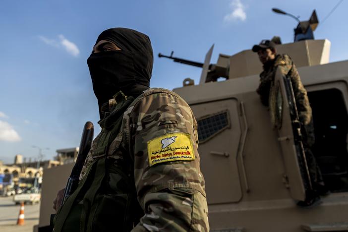 U.S.-backed Syrian Democratic Forces (SDF) fighters stand guard at Al Naeem Square in Raqqa, Syria, in February 2022.