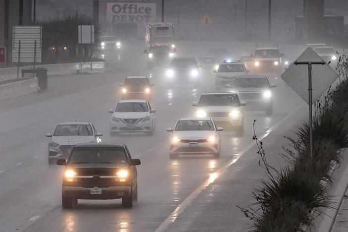 Vehicles make their way on a rain soaked highway in Dallas on Thursday.