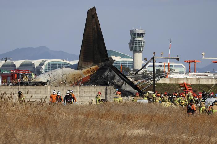 Firefighters and rescue team members work at Muan International Airport in Muan, South Korea, Sunday.
