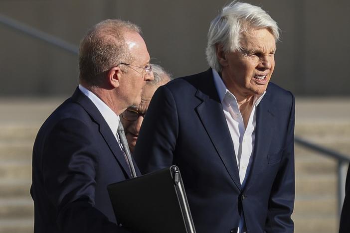 Michael Jeffries (right), former CEO of Abercrombie & Fitch, exits the federal courthouse after his arraignment on sex trafficking and interstate prostitution charges Oct. 25 in Central Islip, N.Y.