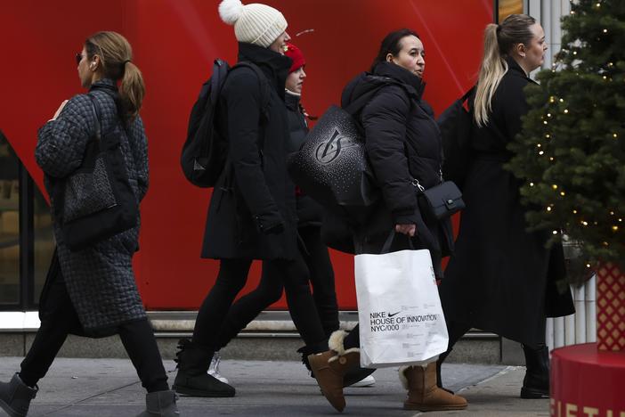 Shoppers walk along Fifth Avenue on Nov. 29 in New York City.