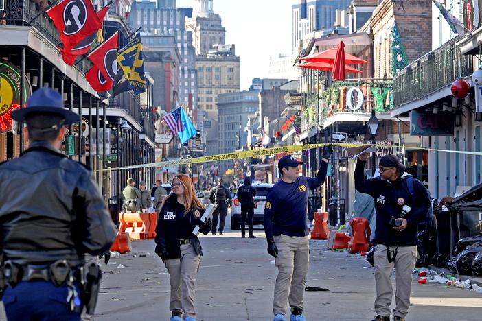 Law enforcement officers from multiple agencies work the scene on Bourbon Street after a person drove a truck into the crowd.