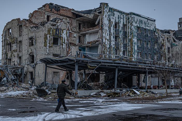 A man walks down a war-ravaged street in Pokrovsk, an industrial city in eastern Ukraine's Donetsk region, on Dec. 19, 2024. Behind him is the hotel Druzhba, which was destroyed by a Russian missile last summer. Pokrovsk was once home to 60,000 people. Now it's largely abandoned, with Russian troops active within a mile of the outskirts.