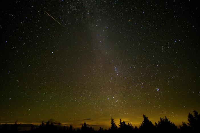 In this 30 second exposure, a meteor streaks across the sky during the annual Perseid meteor shower Friday, Aug. 12, 2016 in Spruce Knob, W. Va.