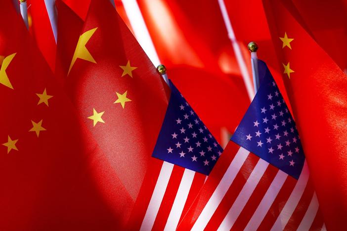 American flags are displayed with Chinese flags on top of a trishaw on Sept. 16, 2018, in Beijing.