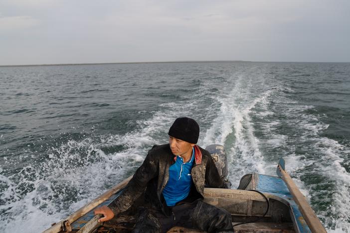 Fisherman Omerserik Ibragimov heads out to put his nets in the water of the Aral Sea in Kazakhstan on Aug. 7. <a href="https://www.npr.org/series/g-s1-30988/aral-sea"target="_blank"   >Click here for the full story. </a>