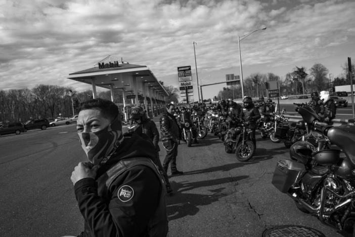 Jossiel Estefes "Onex stands beside his bike in a gas station in Connecticut during a ride.