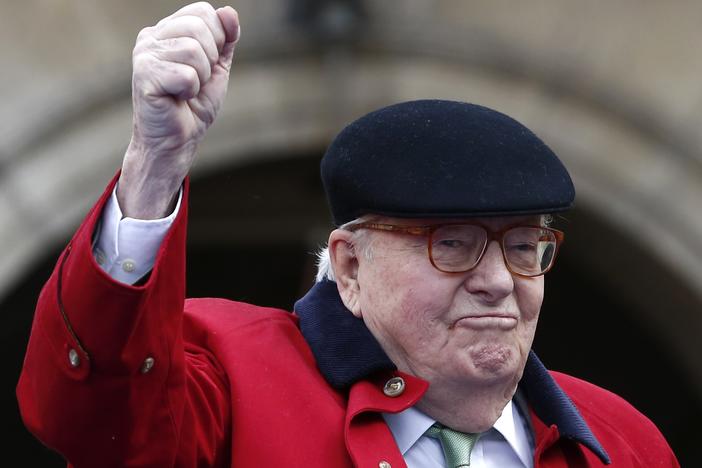 Former far-right National Front party leader Jean-Marie Le Pen clenches his fist at the statue of Joan of Arc in Paris in 2017