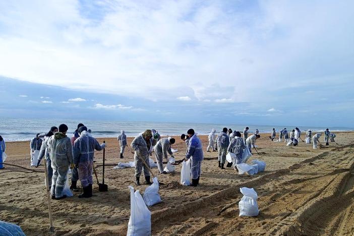 Rescuers and volunteers work to clean up tons of fuel oil that spilled out of two storm-stricken tankers more than two weeks ago in the Kerch Strait, near Anapa in Russia's southern Krasnodar region.