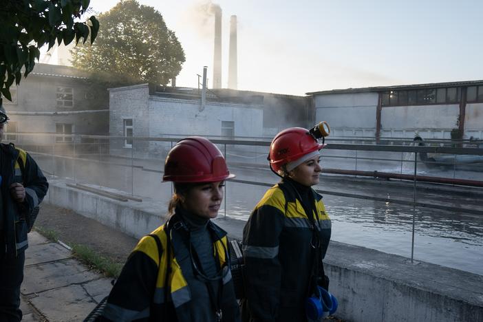 Tetiana Medvedenko (left) and Iryna Ostanko (right), both underground machine operators, walk to the elevators that will take them below the surface into a DTEK coal mine near Ternivka, Ukraine.