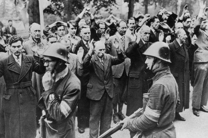 Armed Dutch patriots round up fellow townspeople accused of collaborating with the Nazis in Nijmegen in October 1944.