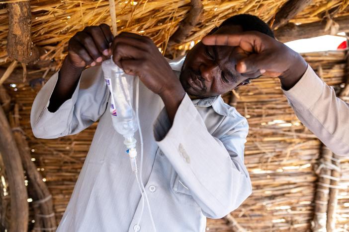 The war in Sudan has taken a toll on the country's medical profession -- interrupting medical education and driving doctors out of the country. Above: 36-year-old doctor and Sudanese refugee Yassin Ishag Dawod is now a refugee in Chad; above, he gets an intravenous drip ready while attending a patient in the Farchana refugee camp.