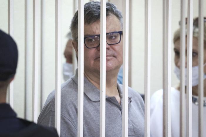 Viktar Babaryka, a former presidential hopeful, stands inside a defendants' cage during his trial in Minsk, Belarus, on July 6, 2021.