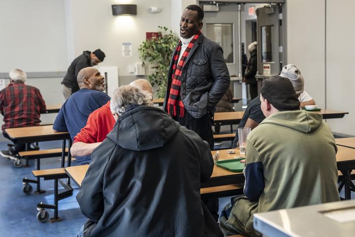 Ron Stanley Jr. (standing), a pastor who serves as the vice president of men's ministry, socializes with residents and supporters of Central Union Mission in Washington, D.C.