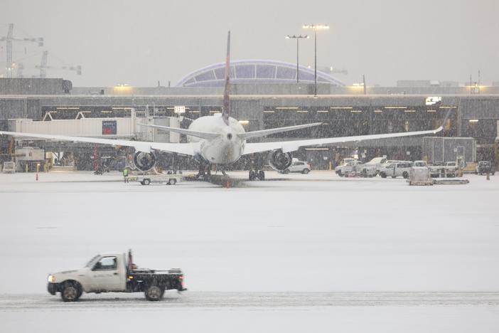 Snow blankets the Hartsfield-Jackson Atlanta International Airport on Friday as a winter storm moves into the Atlanta area.