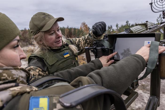 Tetiana (left) and Olena, members of the female air defense unit known as the "Combat Witches of Bucha," assemble a Maxim machine gun during training in the Kyiv region, Ukraine