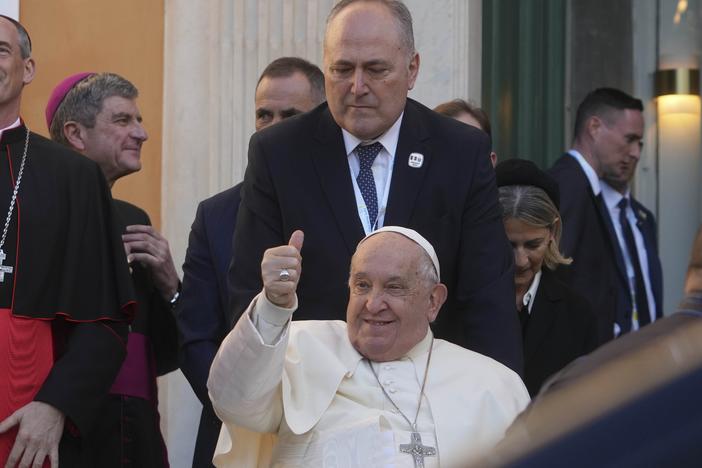 Pope Francis greets faithful during a visit to the French island of Corsica on Dec. 15. President Biden has awarded Pope Francis the Presidential Medal of Freedom with distinction.