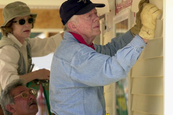 Former President Jimmy Carter and his wife, Rosalynn Carter, attach siding to the front of a Habitat for Humanity home being built on June 10, 2003, in LaGrange, Georgia.