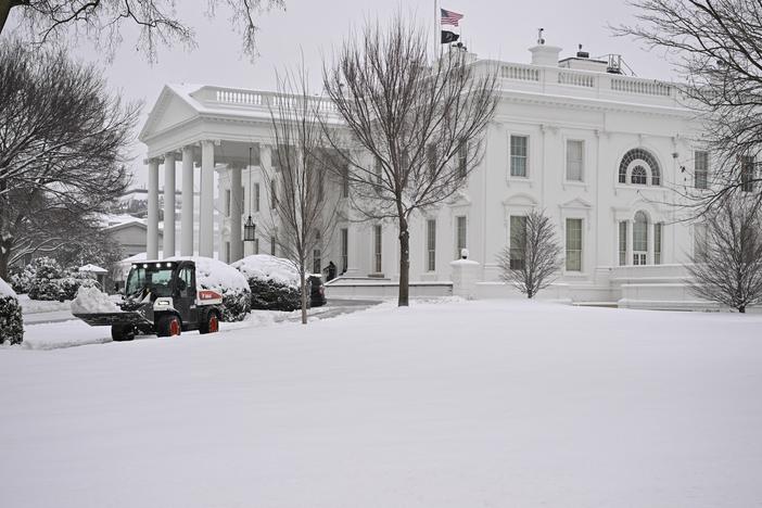 Workers remove snow from a sidewalk at the White House this month. A massive storm system dumped heavy snow and freezing rain on large swaths of the eastern United States, bringing an unusual amount to snow to the region.