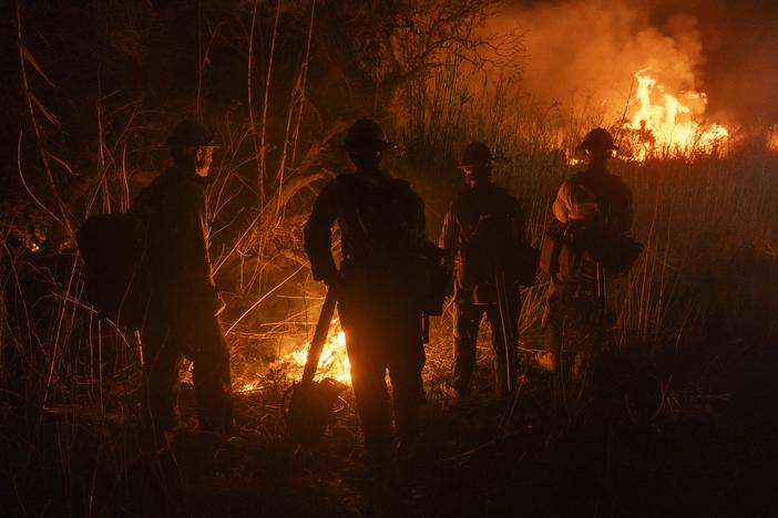 Firefighters monitor and control the spread of the Auto Fire in Oxnard, Calif., northwest of Los Angeles on Jan. 13, 2025.