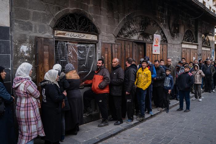 Syrians wait at a breadline at a bakery in the Syrian capital Damascus as the government faces a serious challenge: providing cheap bread. Men and women tend to queue up in separate lines so they don't bump into each other.