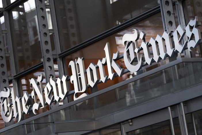 A sign for The New York Times hangs above the entrance to its building, Thursday, May 6, 2021, in New York.  The New York Times filed a federal lawsuit against OpenAI and Microsoft on Wednesday, Dec. 27, 2023, seeking to end the practice of using published material to train chatbots.