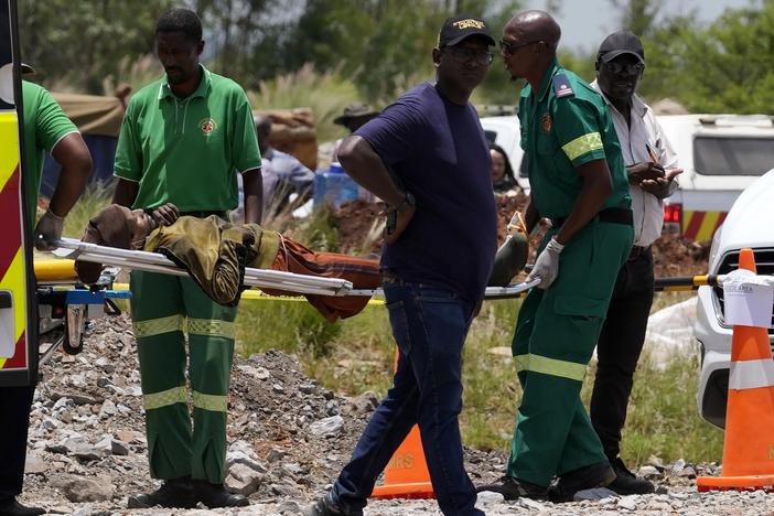 A miner is transported on a stretcher by rescue workers after he was rescued from below ground in an abandoned gold mine in Stilfontein, South Africa on Tuesday.