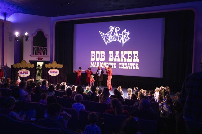 Performers with the Bob Baker Marionette Theater gesture to the crowd of families at Vidiots, a historic theater in northeast Los Angeles, a few miles from where fires are still burning in the Altadena and Pasadena neighborhoods.