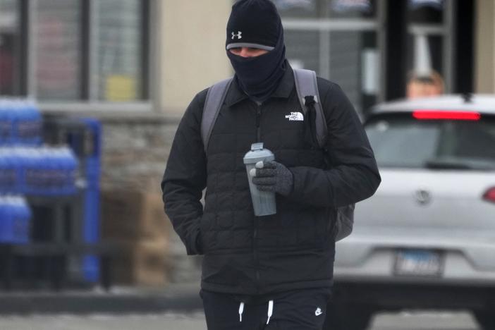 A pedestrian bundles up as he walks on the street during cold weather in Chicago on Jan. 8.