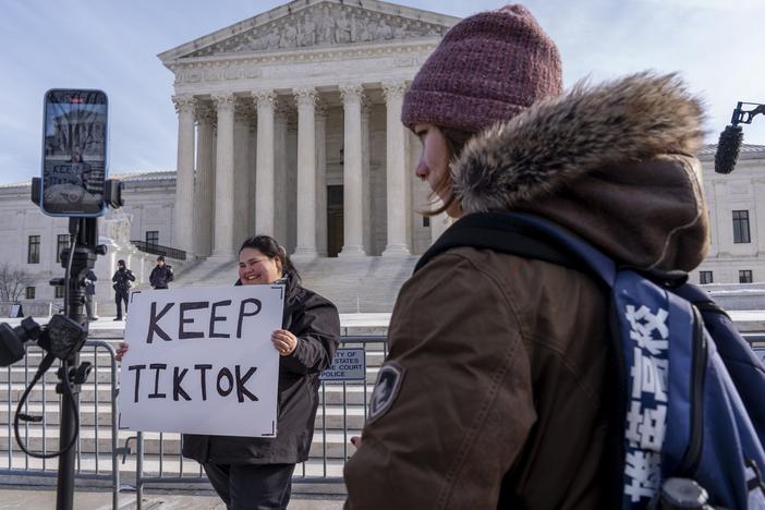Callie Goodwin of Columbia, S.C., holds a sign in support of TikTok outside the Supreme Court on Jan. 10 in Washington, D.C. Goodwin, a small-business owner who sells personalized greeting cards, says 80% of her sales come from people who found her on TikTok.