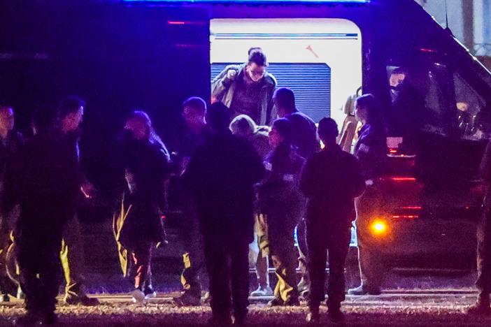 The three released Israeli hostages, who had been abducted during the Oct. 7, 2023, attacks by Palestinian militants, exit a van before boarding an Israeli Air Force military transport helicopter near Reim in southern Israel on Jan. 19 as part of a ceasefire deal.