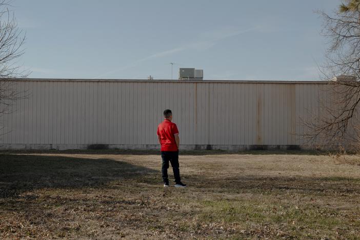 Richie poses for a portrait behind a restaurant last month in Fremont, Neb. Richie left El Salvador earlier this year and crossed to the U.S. through the CBP One app. He is now working at a factory in town. His wife and daughter are still in El Salvador.