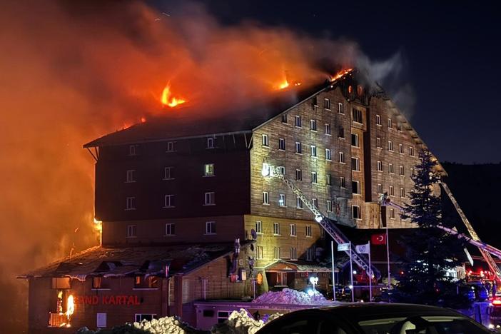 Firefighters work to extinguish a fire in a hotel at a ski resort of Kartalkaya in Bolu province, in northwest Turkey, on Tuesday.