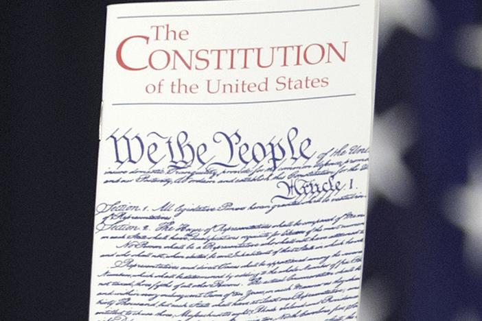 The Constitution is held by a member of Congress on Capitol Hill in Washington on March 23, 2016.
