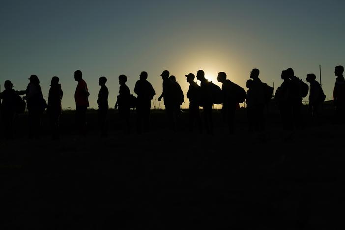 Migrants who crossed the Rio Grande and entered the U.S. from Mexico are lined up for processing by U.S. Customs and Border Protection on Sept. 23, 2023, in Eagle Pass, Texas.