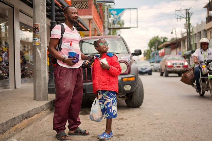 Didier Betofe, from the Congo, Africa, and his 6-year-old son clean windshields and beg for money in the Mexican town of Ciudad Acuña across from Roma, Texas.   Didier arrived in Ecuador and traveled north to Ciudad Acuña, where they have been living the past three months.