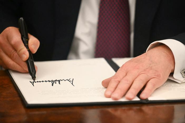 President Trump signs executive orders in the Oval Office of the White House in Washington, D.C., on Monday.