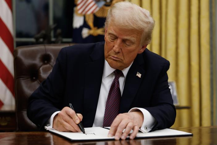 President Trump signs executive actions and orders in the Oval Office of the White House on Monday, hours after taking office for his second term as the 47th president of the United States.
